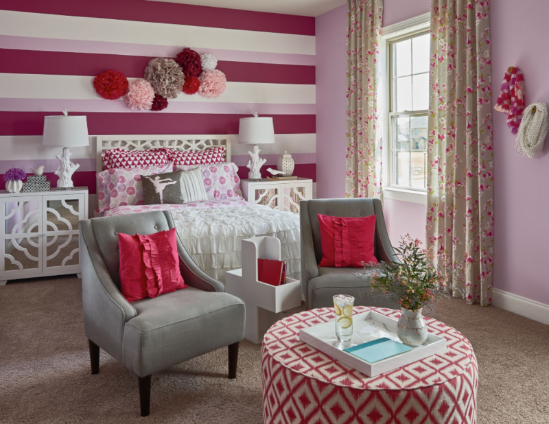 This is an example of a mid-sized traditional kids' room for girls in Charlotte with multi-coloured walls and carpet.