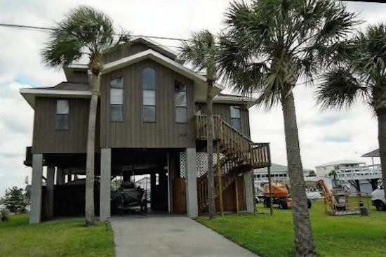 Design ideas for a large three-storey brown exterior in Tampa with wood siding.