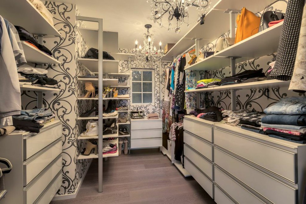 Large modern women's walk-in wardrobe in Miami with white cabinets.