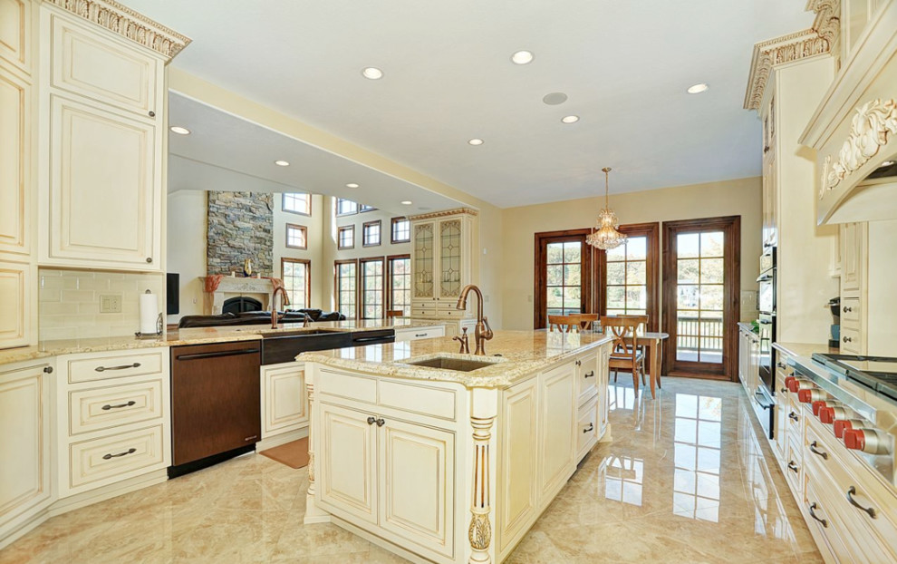 Example of a mid-sized mountain style u-shaped travertine floor open concept kitchen design in Newark with an undermount sink, beaded inset cabinets, beige cabinets, granite countertops, white backsplash, subway tile backsplash, stainless steel appliances and an island
