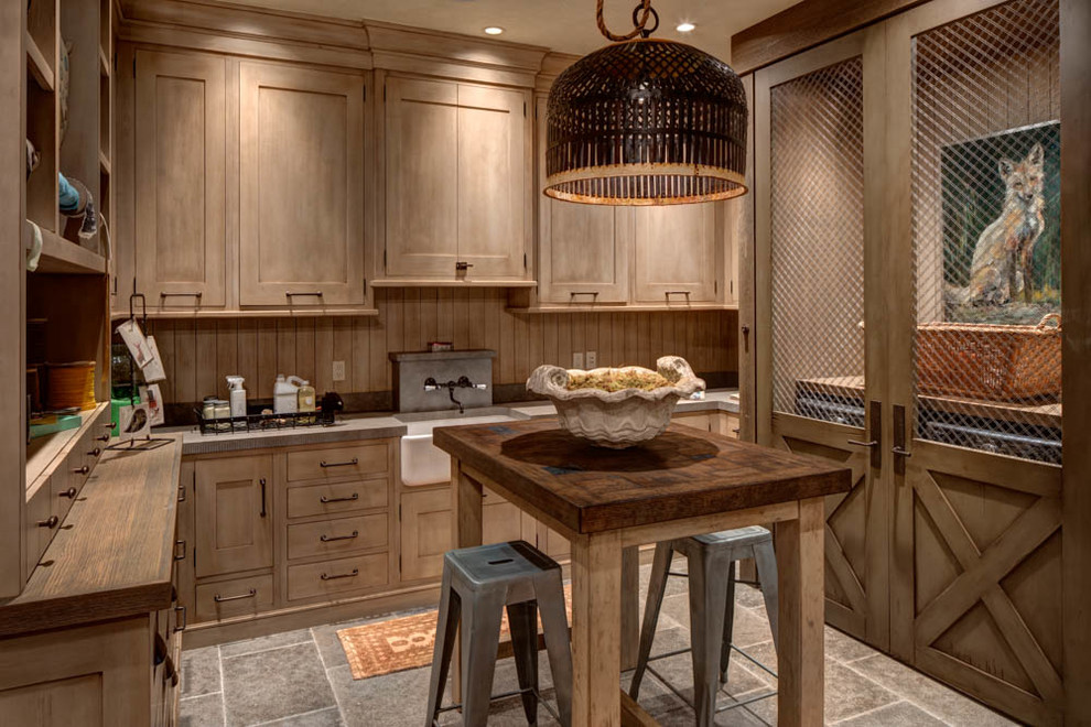 Inspiration for a large country u-shaped dedicated laundry room in Salt Lake City with a farmhouse sink, medium wood cabinets, shaker cabinets and a side-by-side washer and dryer.