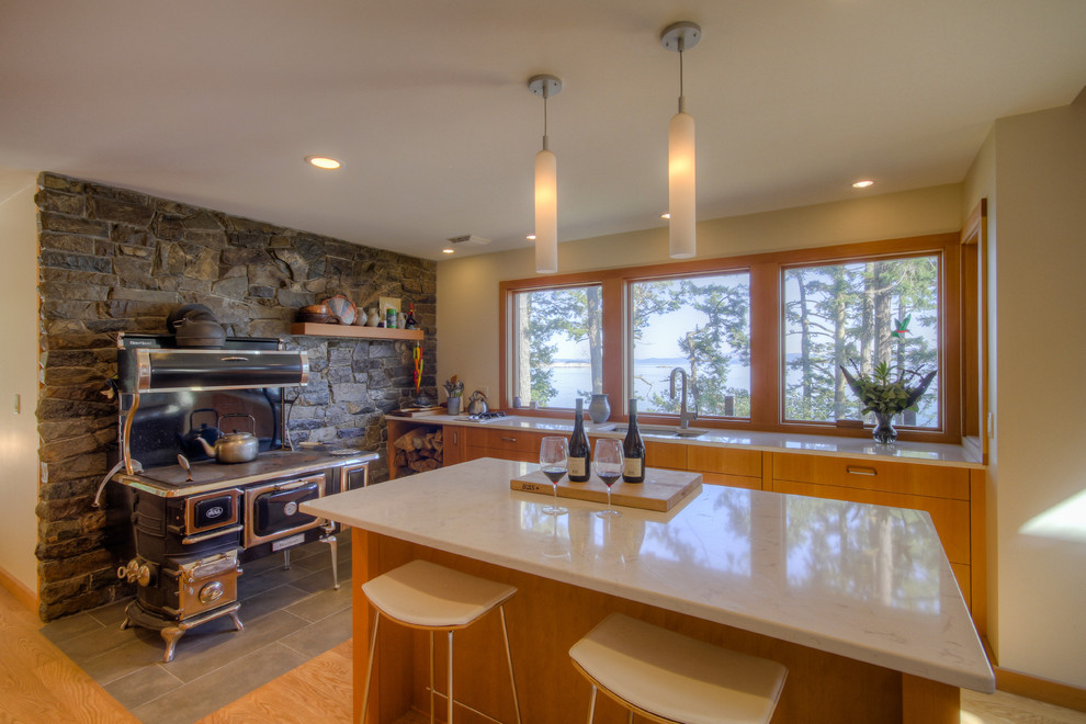 Country kitchen in Vancouver with flat-panel cabinets, medium wood cabinets and beige benchtop.