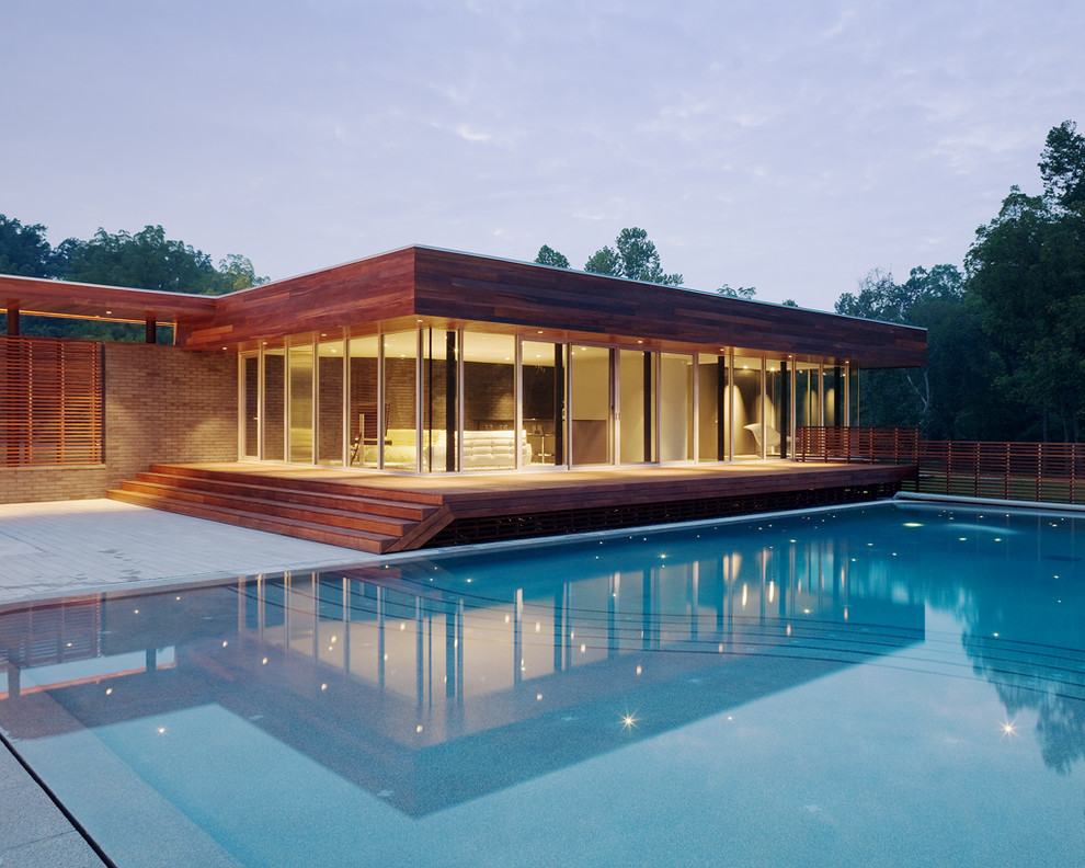 Design ideas for a contemporary pool in Kansas City with a pool house.