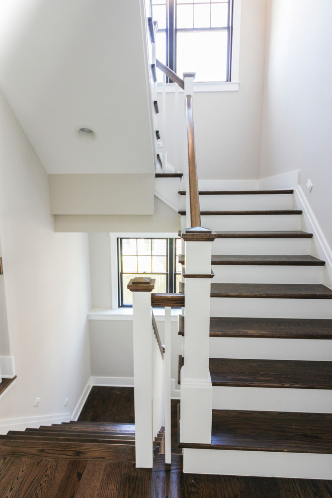 Mid-sized modern travertine u-shaped staircase in DC Metro with wood risers and wood railing.