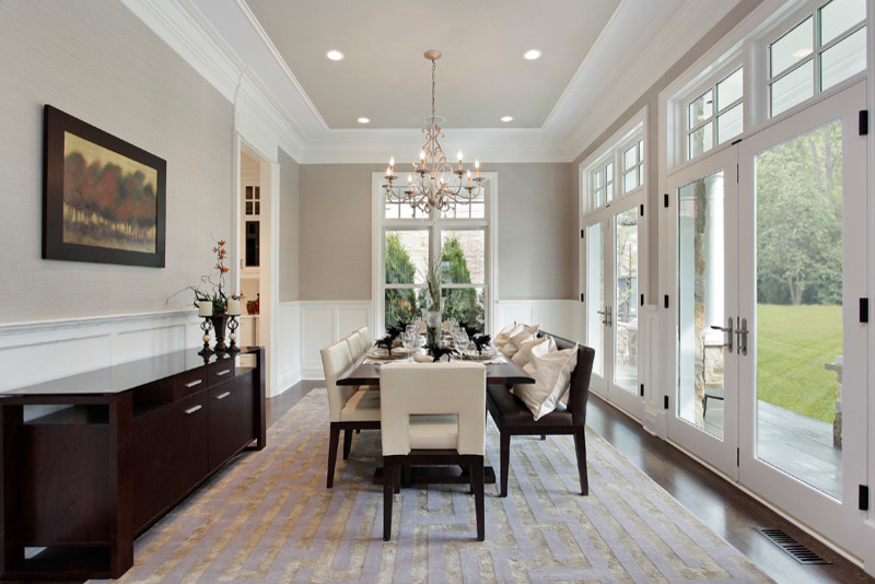 Photo of a large contemporary separate dining room in Chicago with grey walls, dark hardwood floors and brown floor.