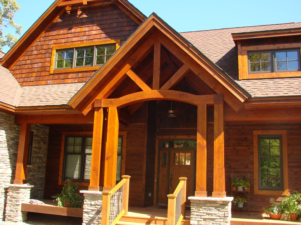 Large country two-storey brown house exterior in Minneapolis with mixed siding, a gable roof and a shingle roof.