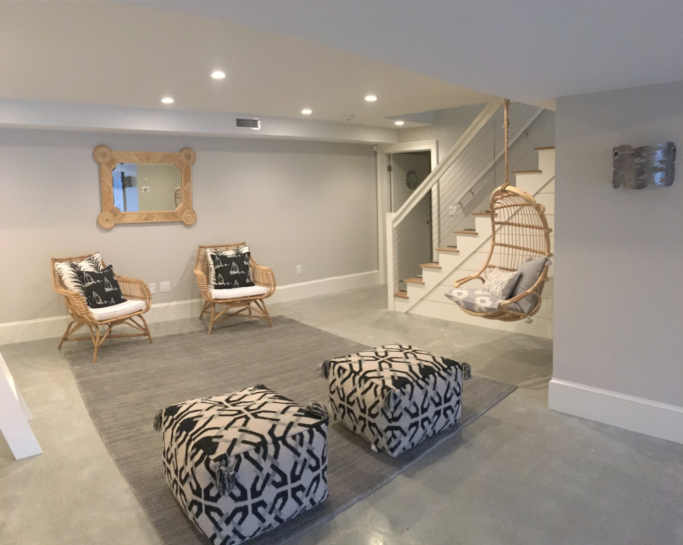 Inspiration for an expansive beach style walk-out basement in Boston with grey walls, concrete floors and grey floor.