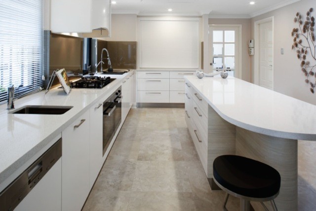 Inspiration for a large contemporary galley eat-in kitchen in Perth with an undermount sink, flat-panel cabinets, white cabinets, quartz benchtops, metallic splashback, glass sheet splashback, stainless steel appliances, porcelain floors and with island.