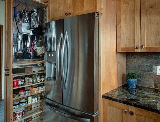 Eat-in kitchen - small rustic galley slate floor and wood ceiling eat-in kitchen idea with a farmhouse sink, shaker cabinets, light wood cabinets, granite countertops, slate backsplash, stainless steel appliances, no island and blue countertops