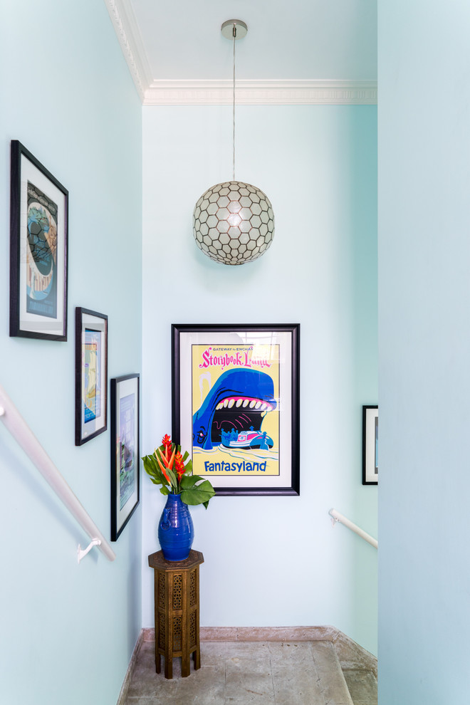 Inspiration for a mid-sized eclectic foyer in Los Angeles with blue walls, vinyl floors, a single front door, a white front door and brown floor.