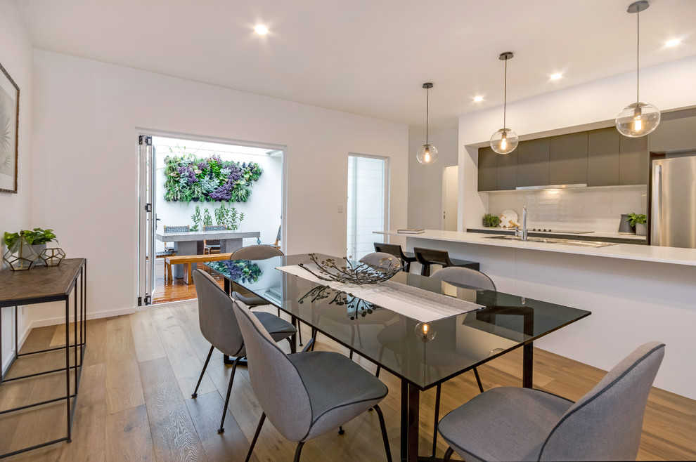 Large contemporary kitchen/dining combo in Sunshine Coast with white walls and vinyl floors.