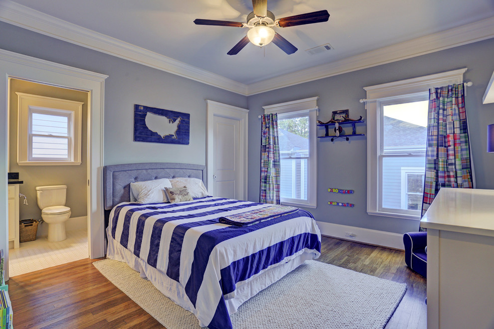 Photo of a mid-sized arts and crafts kids' room for boys in Houston with blue walls and medium hardwood floors.