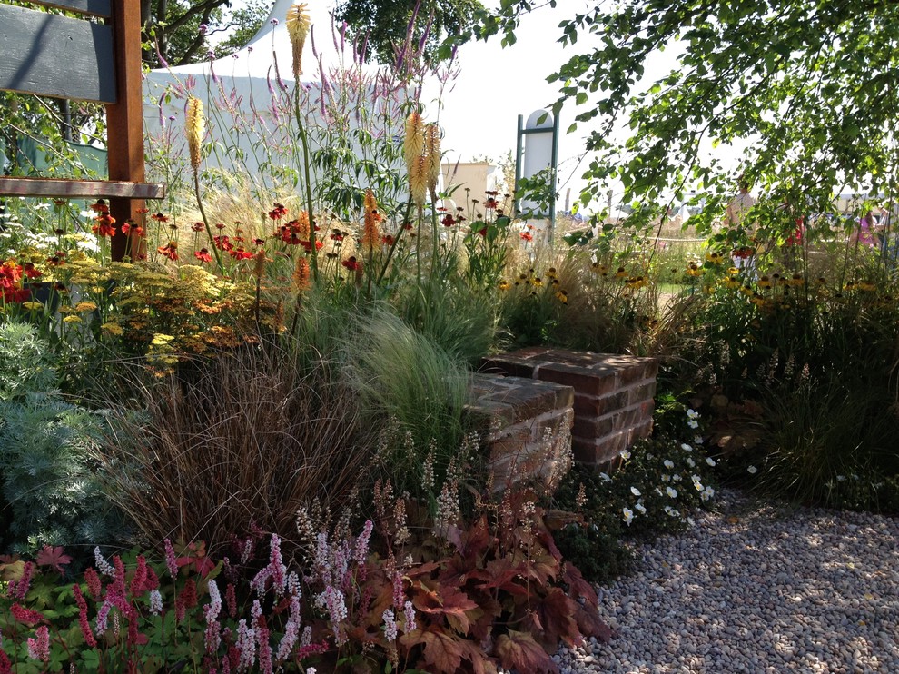 Inspiration for a small country backyard formal garden in Manchester with a container garden and gravel.
