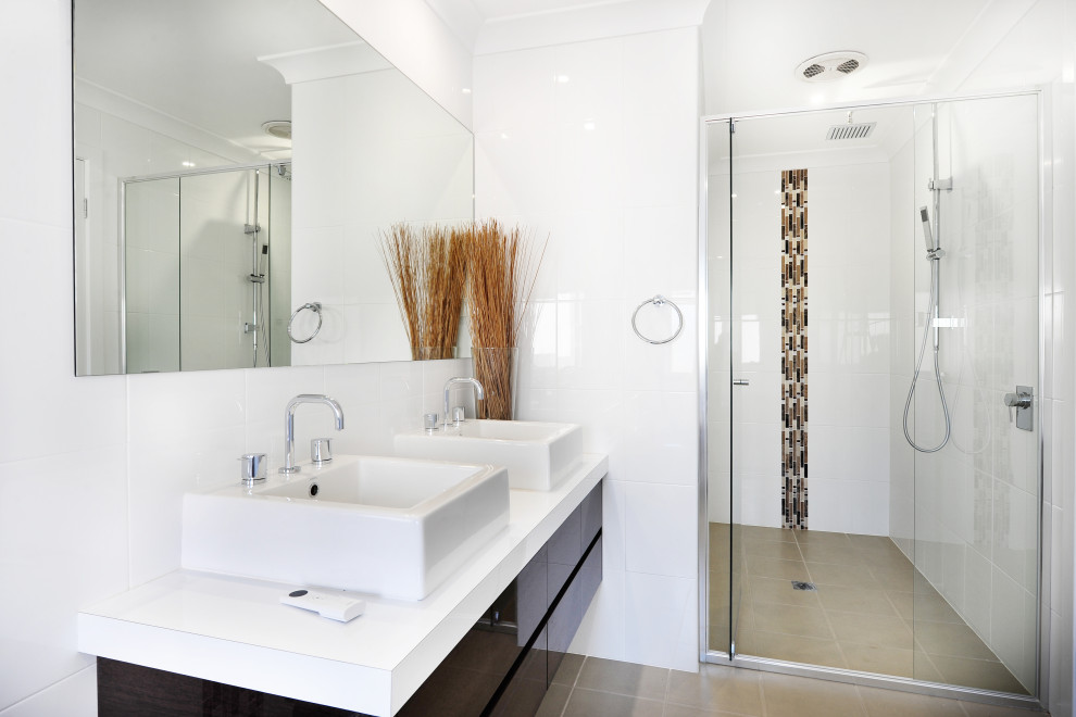 This is an example of a small contemporary bathroom in Other with brown cabinets, an alcove shower, white tile, ceramic tile, engineered quartz benchtops, a hinged shower door, white benchtops, a double vanity and a floating vanity.