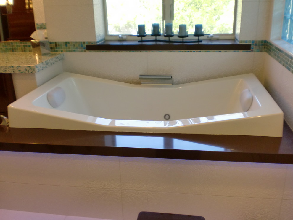 Large modern master bathroom in Orange County with dark wood cabinets, a hot tub, blue tile, multi-coloured tile, porcelain floors, granite benchtops, flat-panel cabinets, an alcove shower, glass sheet wall, white walls and an undermount sink.