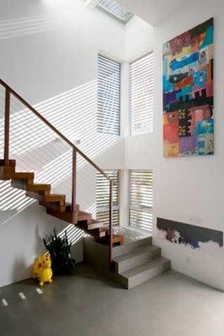 Design ideas for a mid-sized contemporary wood straight staircase in Los Angeles with open risers.