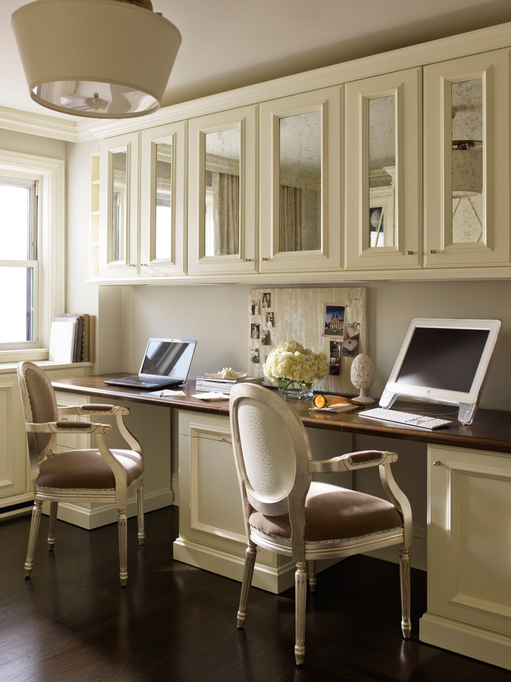 Study room - transitional built-in desk dark wood floor study room idea in New York with gray walls