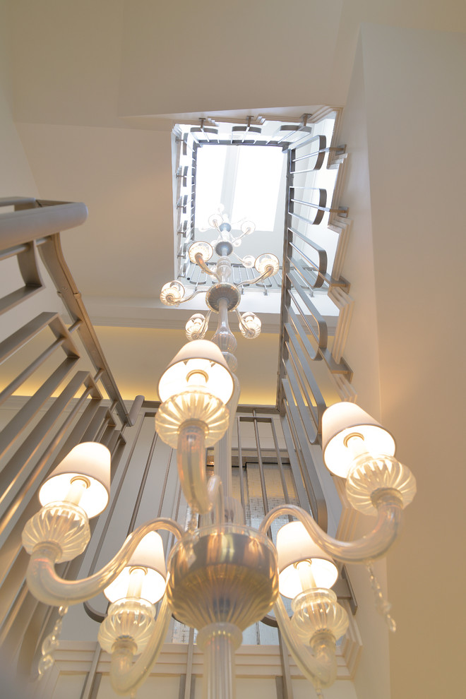 Photo of a large contemporary metal floating staircase in London with metal risers.