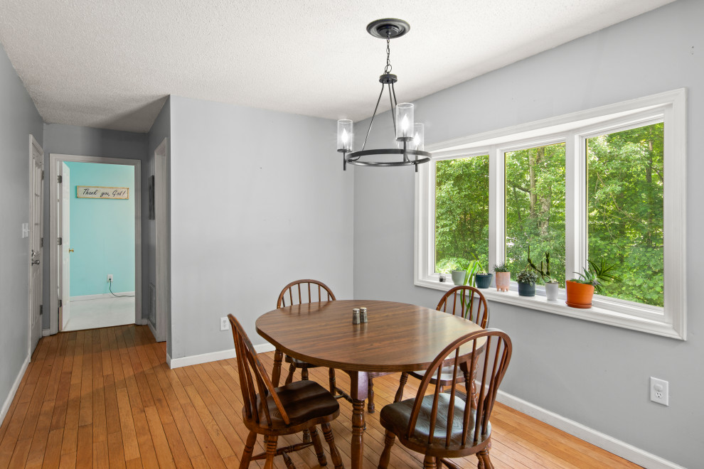 Inspiration for a transitional medium tone wood floor and brown floor kitchen/dining room combo remodel with white walls