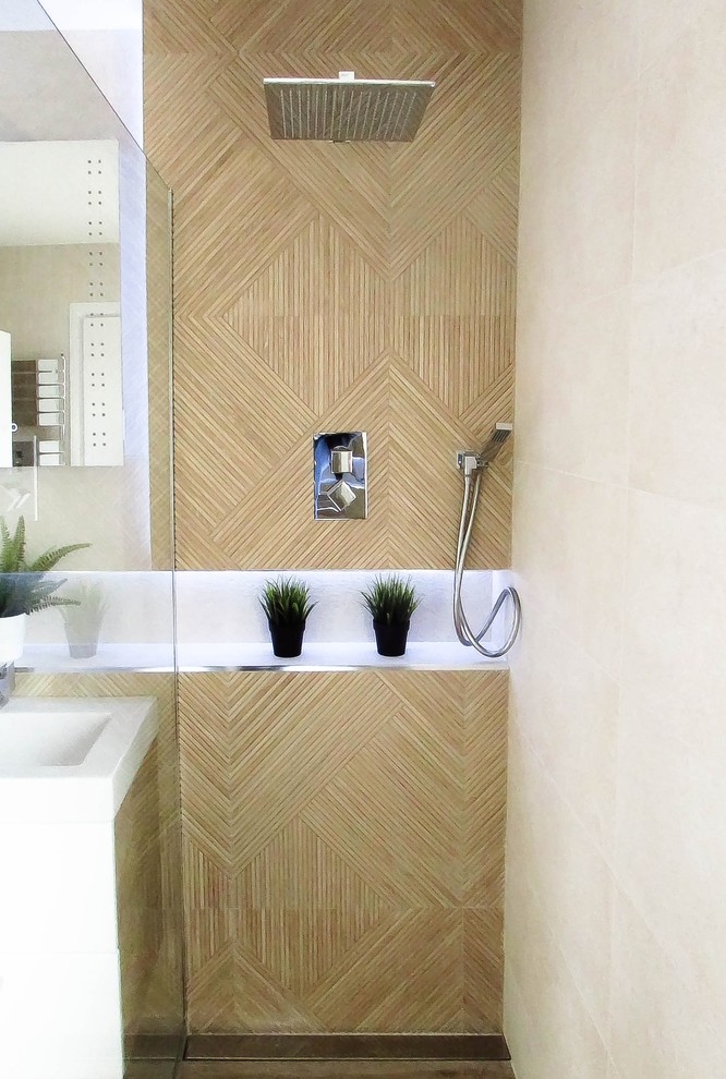 Photo of a small contemporary master bathroom in Other with furniture-like cabinets, white cabinets, a drop-in tub, a shower/bathtub combo, a wall-mount toilet, beige tile, porcelain tile, beige walls, porcelain floors, a wall-mount sink, tile benchtops, beige floor, an open shower and white benchtops.