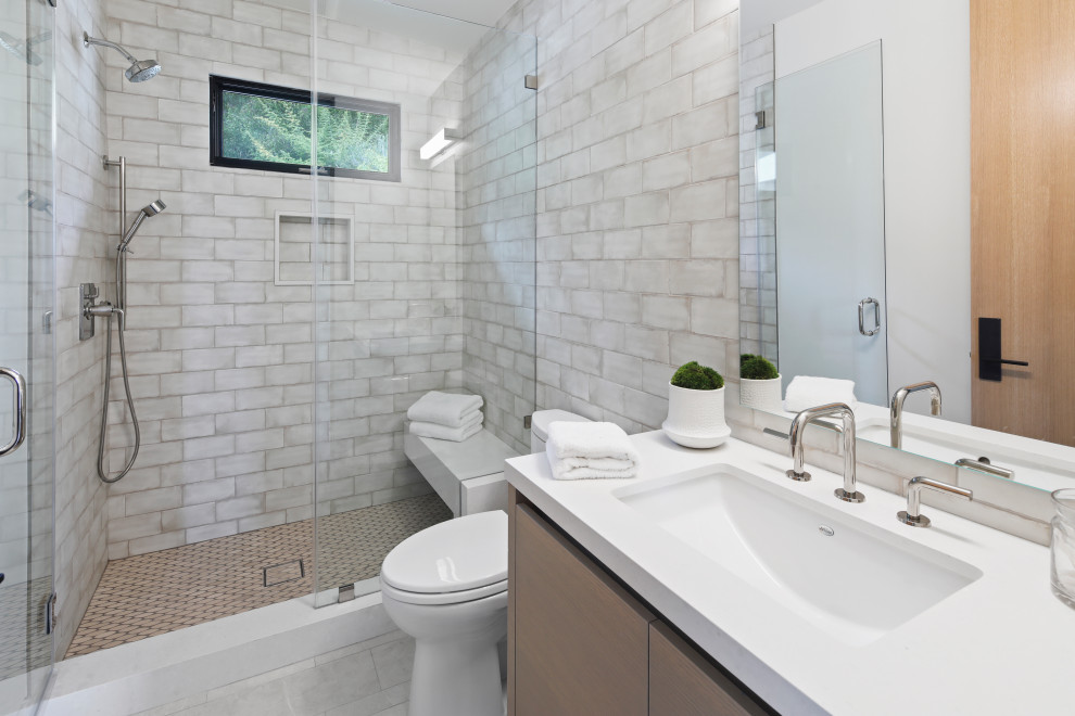 Design ideas for a mid-sized contemporary 3/4 bathroom in Los Angeles with flat-panel cabinets, beige cabinets, an alcove shower, a two-piece toilet, gray tile, white walls, porcelain floors, an undermount sink, grey floor, a hinged shower door and white benchtops.