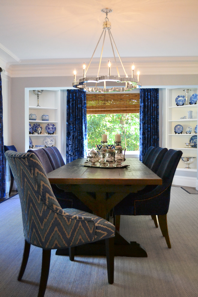 Large eclectic separate dining room in San Francisco with blue walls, dark hardwood floors and brown floor.