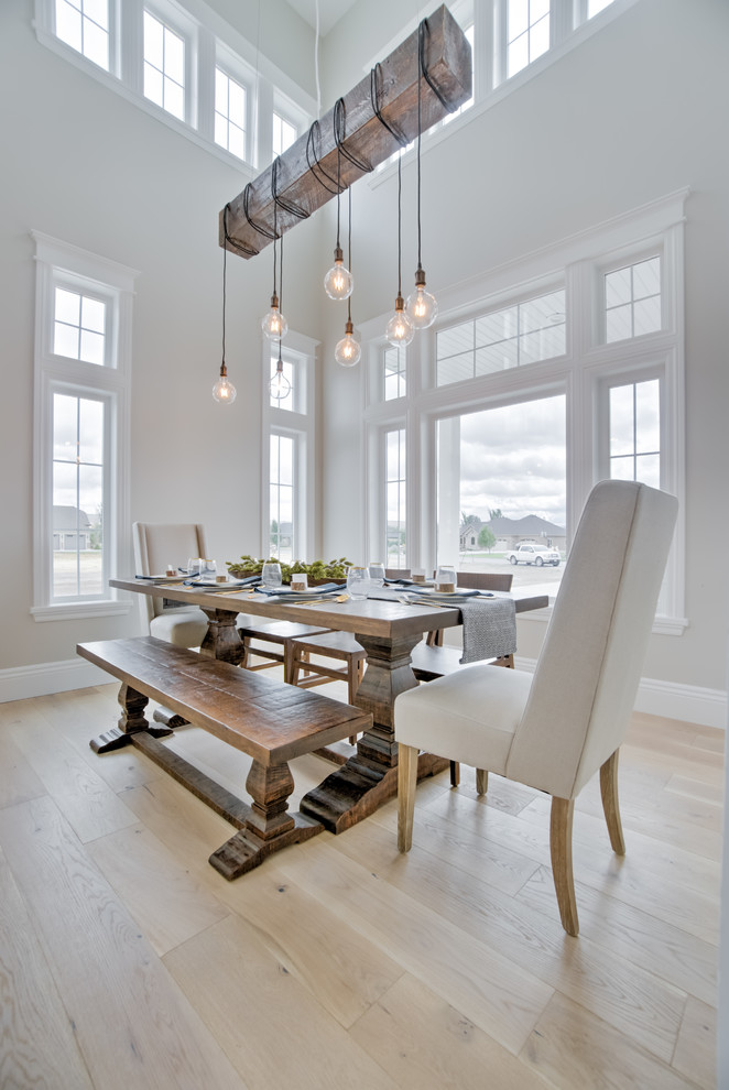 Country dining room in Other with light hardwood floors, white walls and beige floor.