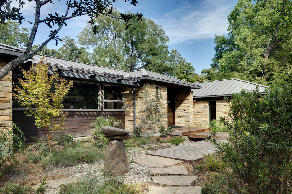 This is an example of a contemporary exterior in Dallas with stone veneer.