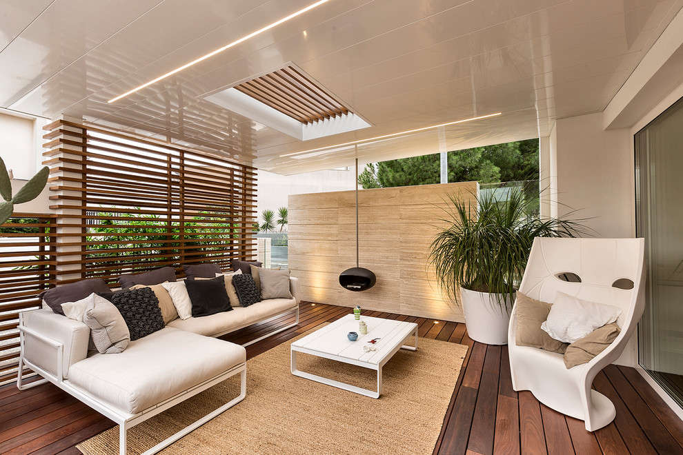 Mid-sized contemporary backyard patio in Bari with decking and a pergola.