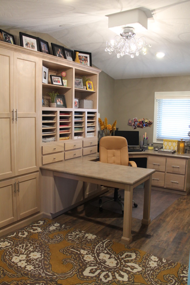 Design ideas for a large traditional craft room in Other with beige walls, dark hardwood floors and a built-in desk.