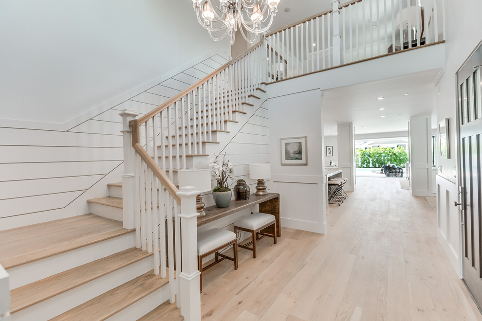 Design ideas for a large contemporary wood curved staircase in Los Angeles with wood risers and wood railing.