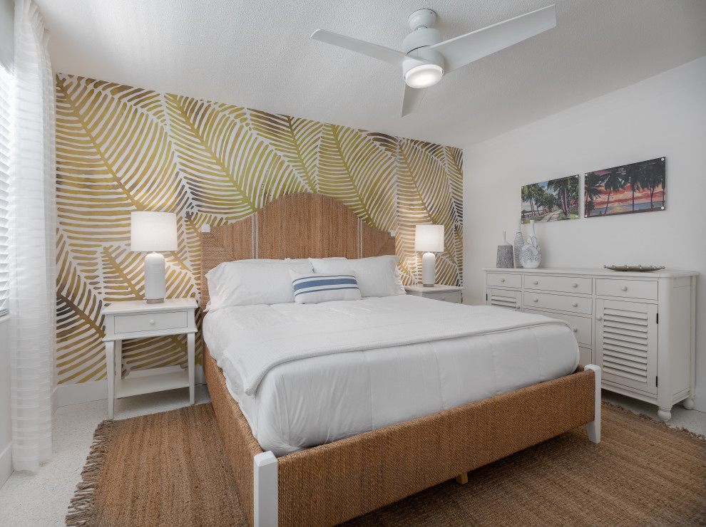 This is an example of a small beach style master bedroom in Tampa with white walls, ceramic floors and white floor.