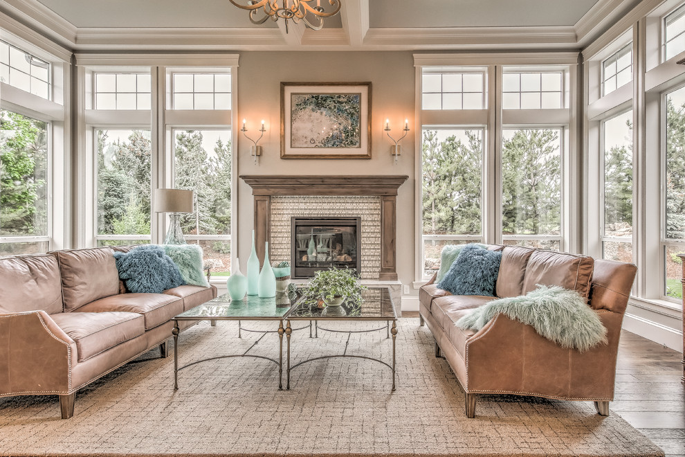Inspiration for a mid-sized traditional open concept living room in Boise with beige walls, dark hardwood floors, a standard fireplace, a tile fireplace surround, no tv and brown floor.
