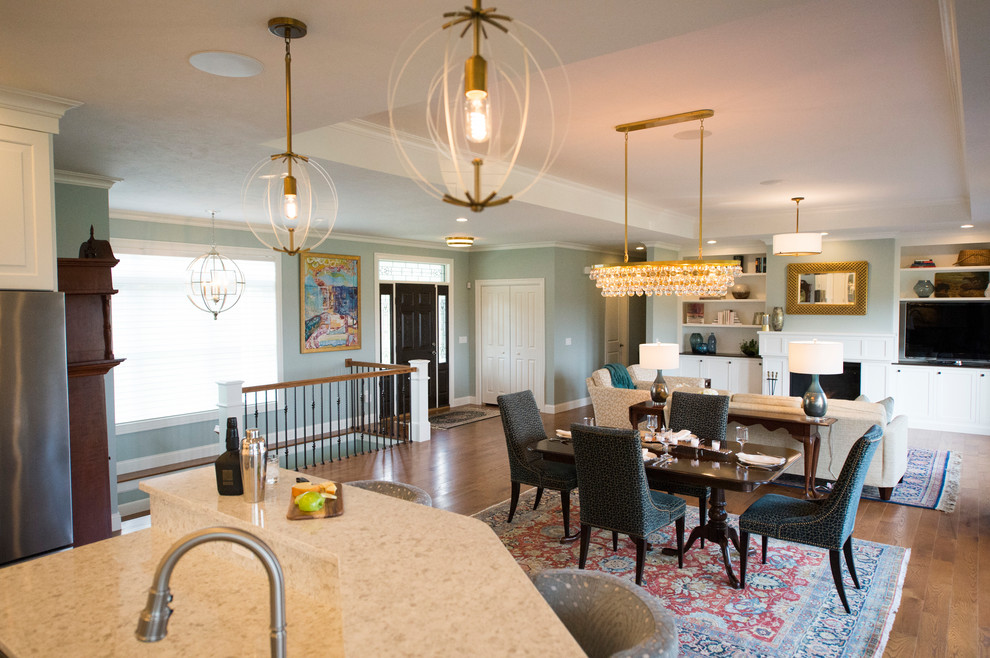 Eat-in kitchen - transitional l-shaped medium tone wood floor eat-in kitchen idea in Boston with white cabinets, granite countertops, gray backsplash, stainless steel appliances and an island