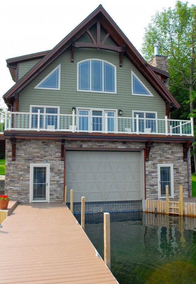 Large arts and crafts three-storey green exterior in Other with vinyl siding.