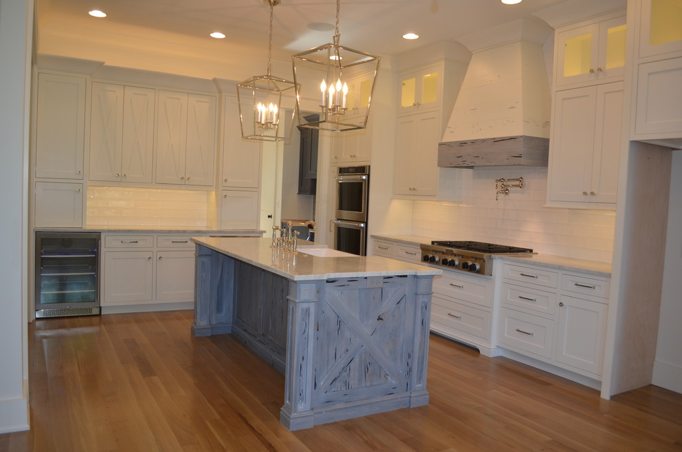 Inspiration for a large transitional separate kitchen in Other with a farmhouse sink, beaded inset cabinets, white cabinets, quartz benchtops, white splashback, subway tile splashback, stainless steel appliances, medium hardwood floors and with island.