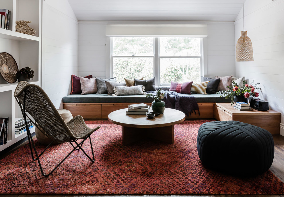 Photo of a contemporary living room in Sydney with white walls and dark hardwood floors.