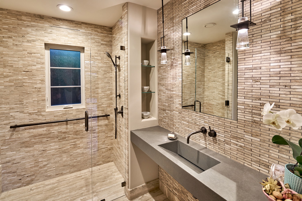 Design ideas for a mid-sized transitional 3/4 bathroom in San Francisco with a wall-mount toilet, stone tile, beige walls, limestone floors, an integrated sink, concrete benchtops, a curbless shower, beige tile and a hinged shower door.