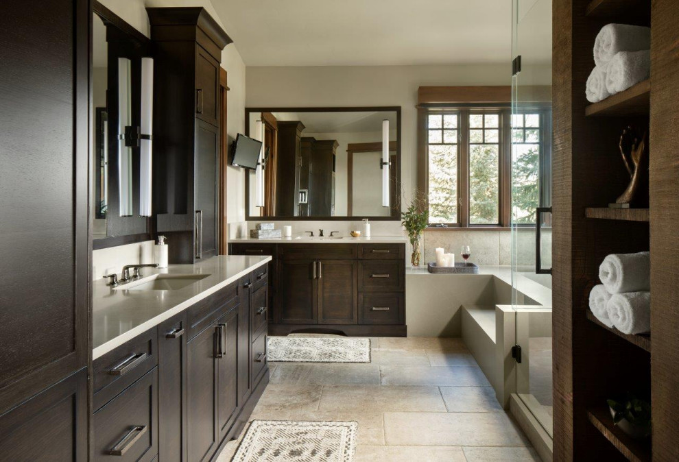 Photo of a large country master bathroom in Denver with dark wood cabinets, white benchtops, shaker cabinets, beige tile, beige walls, an undermount sink, beige floor, a single vanity and a built-in vanity.