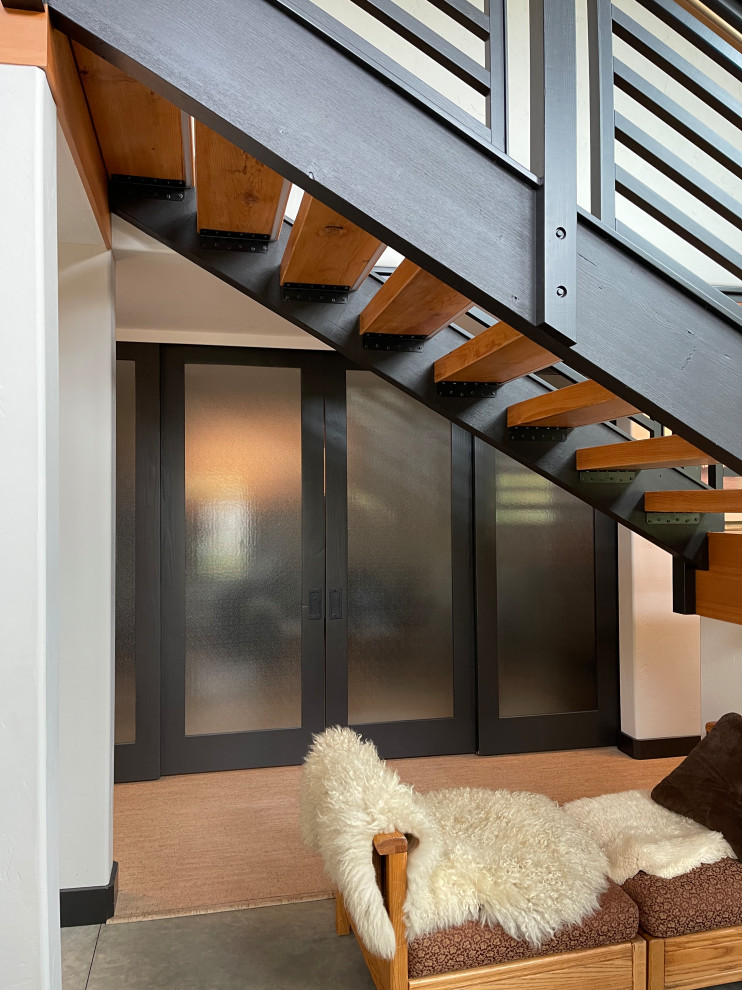 Mid-sized beach style wood l-shaped staircase in Seattle with open risers, wood railing and wood walls.