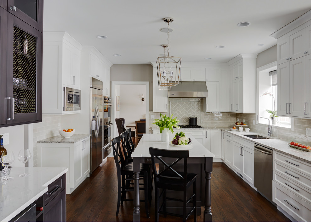 Example of a large transitional u-shaped medium tone wood floor open concept kitchen design in Chicago with a double-bowl sink, flat-panel cabinets, white cabinets, quartz countertops, beige backsplash, subway tile backsplash, stainless steel appliances and an island