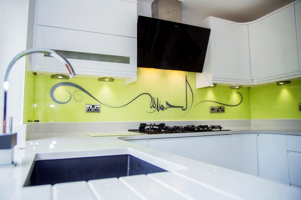 Inspiration for a contemporary kitchen in Hertfordshire with yellow splashback and glass sheet splashback.
