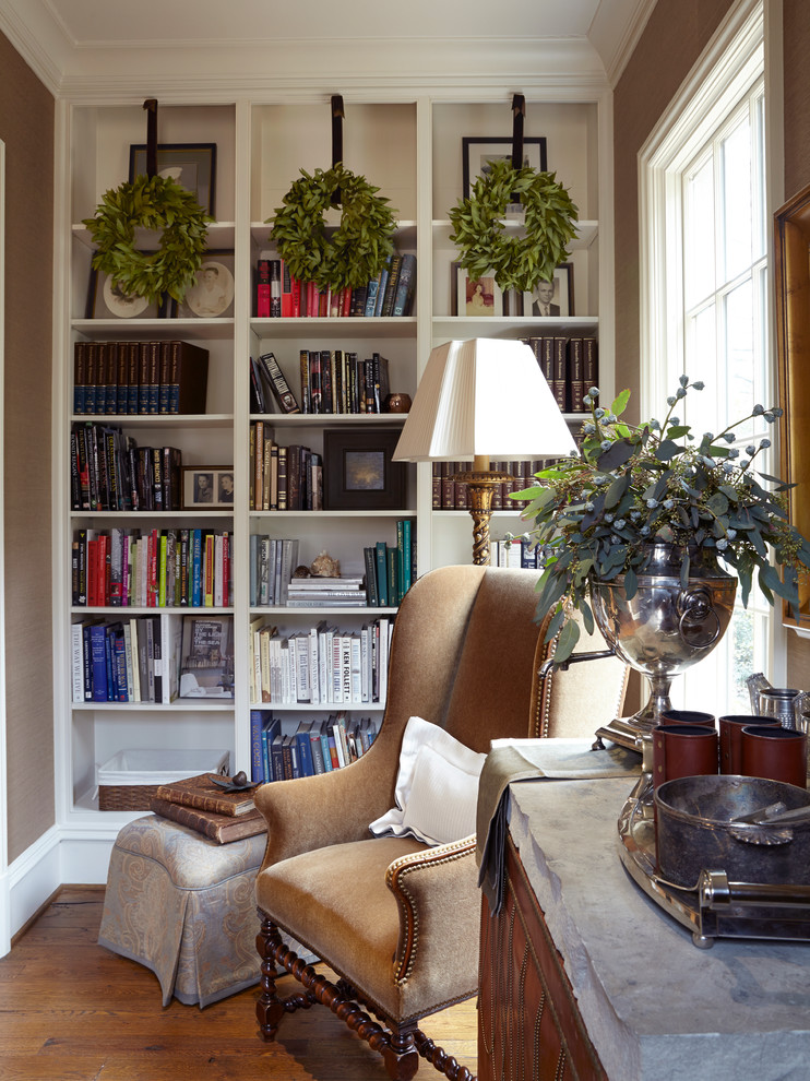 Photo of a traditional family room in Birmingham with brown walls, dark hardwood floors and a library.