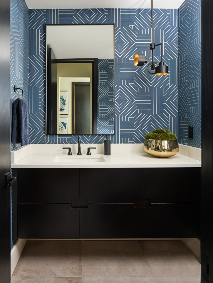 Small contemporary cloakroom in Denver with flat-panel cabinets, dark wood cabinets, a one-piece toilet, blue walls, limestone flooring, a submerged sink, engineered stone worktops, grey floors, white worktops, a floating vanity unit and wallpapered walls.