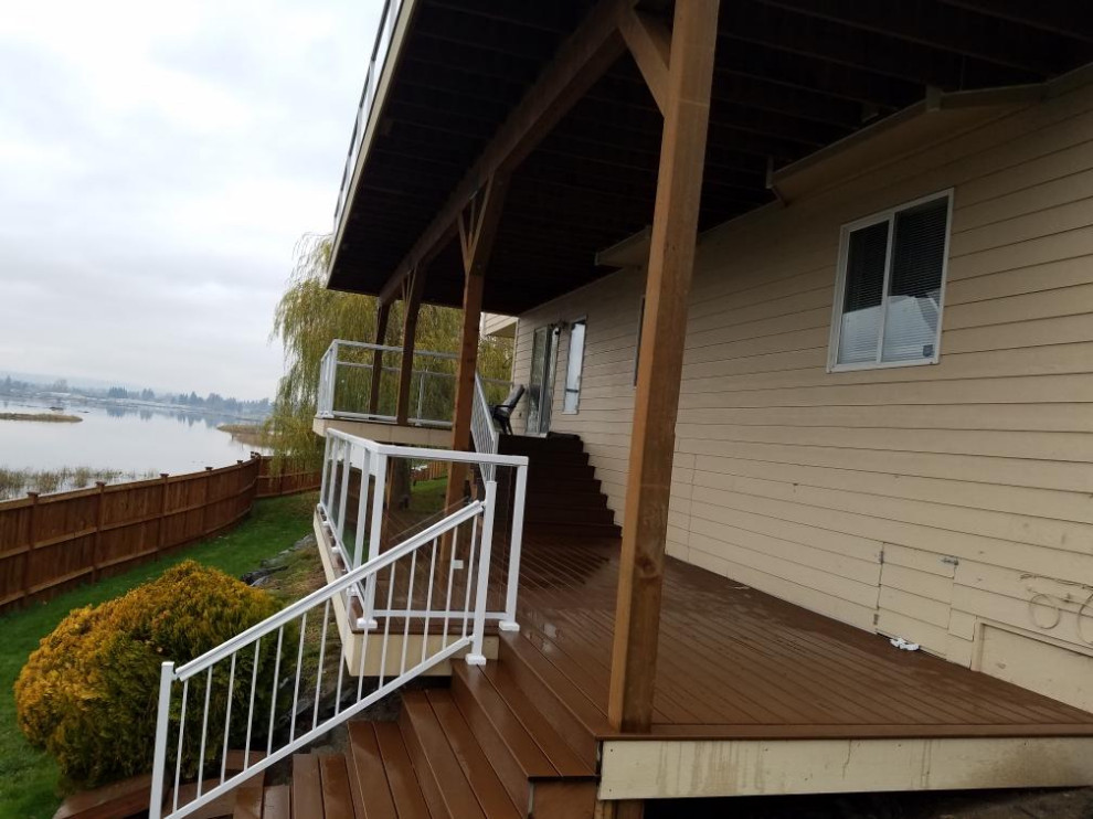 Large minimalist backyard deck photo in Seattle with no cover