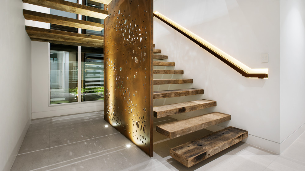 Design ideas for a large contemporary wood floating staircase in Sydney with open risers and mixed railing.