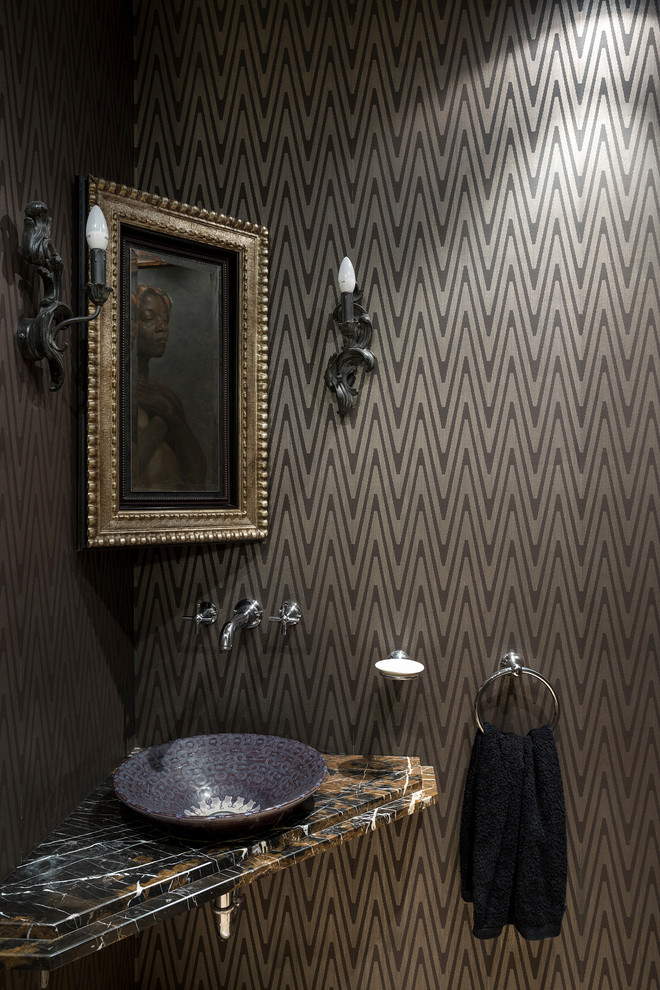 This is an example of a small eclectic powder room in Moscow with brown walls, marble benchtops and a vessel sink.