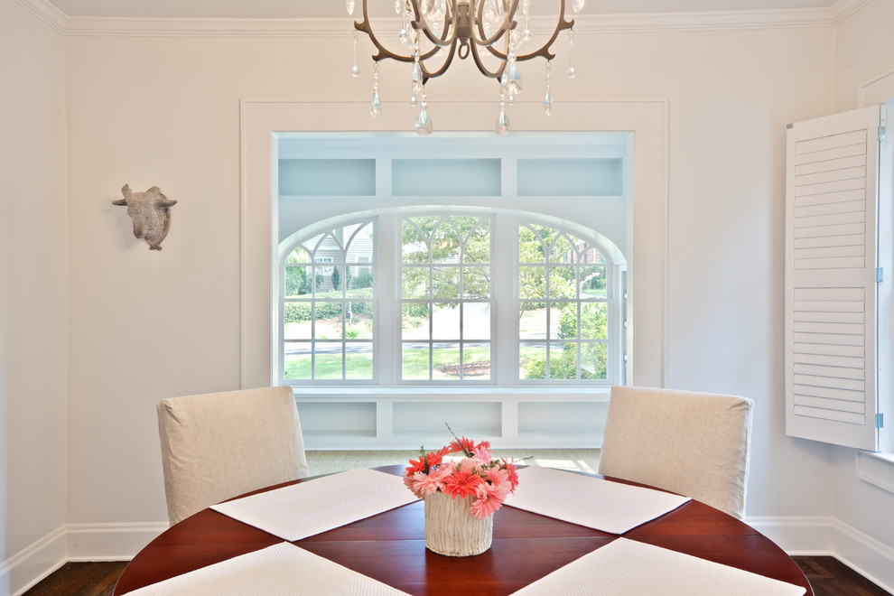 Photo of a traditional dining room in Atlanta with white walls and dark hardwood floors.