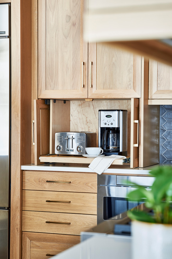 Example of a mid-sized transitional kitchen design in Atlanta with flat-panel cabinets, light wood cabinets, quartz countertops, stainless steel appliances, an island and white countertops