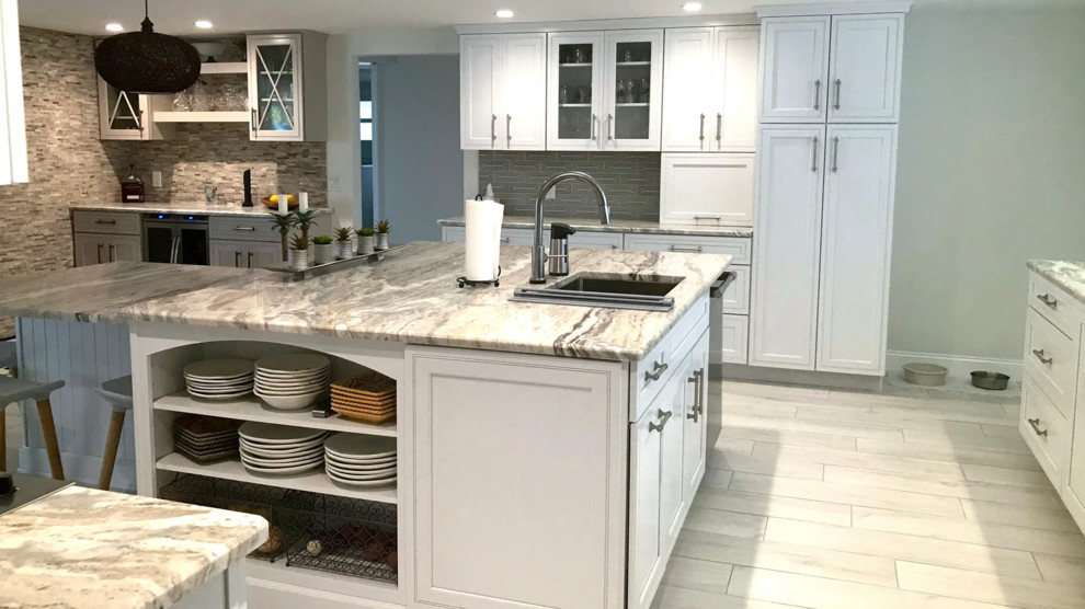 Eat-in kitchen - mid-sized transitional u-shaped porcelain tile and gray floor eat-in kitchen idea in Boston with an undermount sink, beaded inset cabinets, white cabinets, granite countertops, gray backsplash, ceramic backsplash, stainless steel appliances, an island and multicolored countertops